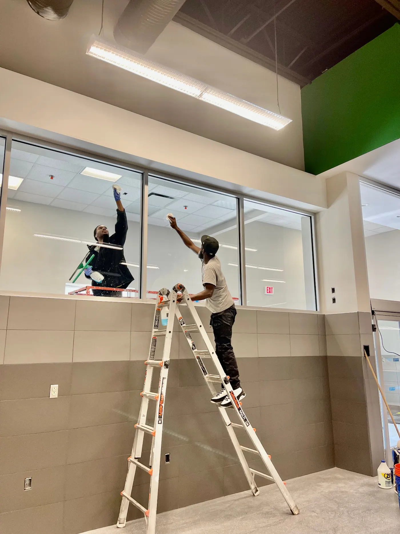 Interior window cleaning by a uniformed Cleaning Concepts Plus team member